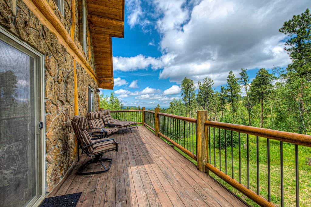Discover your perfect Black Hills escape at this custom log and stone home in Deadwood. Set on ten private acres, this four bedroom retreat is ideal for families, offering a game room, spacious decks with stunning mountain views, and a fire pit for evening relaxation. With direct access to Forest Service land and proximity to Terry Peak, you can enjoy endless outdoor adventures and wildlife spotting. Experience the ideal combination of rustic charm, modern comfort, and natural beauty today.