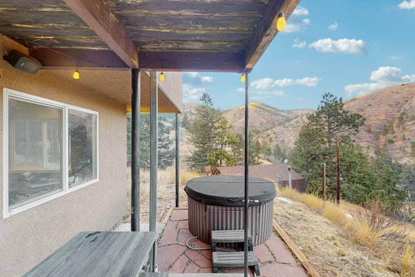 Experience the ultimate mountain getaway at this charming 2-bedroom apartment in Green Mountain Falls. Perfectly positioned with direct access to the Catamount trailhead and routes to Pikes Peak, this dog-friendly retreat features a private hot tub, a fully equipped kitchen, and a scenic patio with mountain views. Ideal for families or groups seeking adventure, you are just moments away from hiking, fishing, and exploring Colorado Springs. Unwind in comfort after a day of outdoor exploration at this peaceful mountain escape.