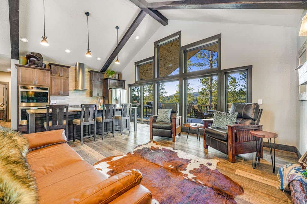 Escape to Pillar Peak Perch, a stunning 5-bedroom luxury lodge nestled in the scenic hills of Sturgis. This modern mountain retreat offers the perfect blend of rustic charm and upscale amenities, including a private hot tub, a spacious game room with a pool table, and a large furnished deck with mountain views. Ideally located for adventure, you are minutes away from world-class hiking, mountain biking, and iconic landmarks like Mount Rushmore and Deadwood. Your ultimate South Dakota getaway awaits.
