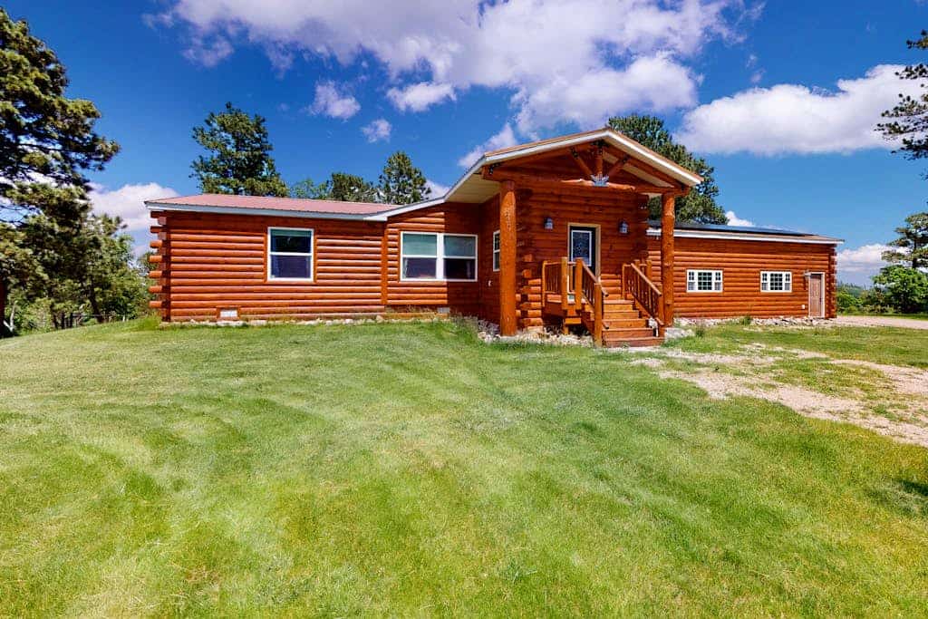 Escape to The Great Escape, a beautiful 3-bedroom log cabin in the heart of the Black Hills. Perfect for families and your dog, this contemporary retreat offers stunning mountain views and a cozy fireplace for chilly evenings. Enjoy private deck barbecues after exploring the rich Gold Rush history of nearby Deadwood, Lead, and Terry Peak. This peaceful home base provides all the comforts of home in a scenic setting, making it the ideal spot for your next mountain adventure with friends, family, and pets.