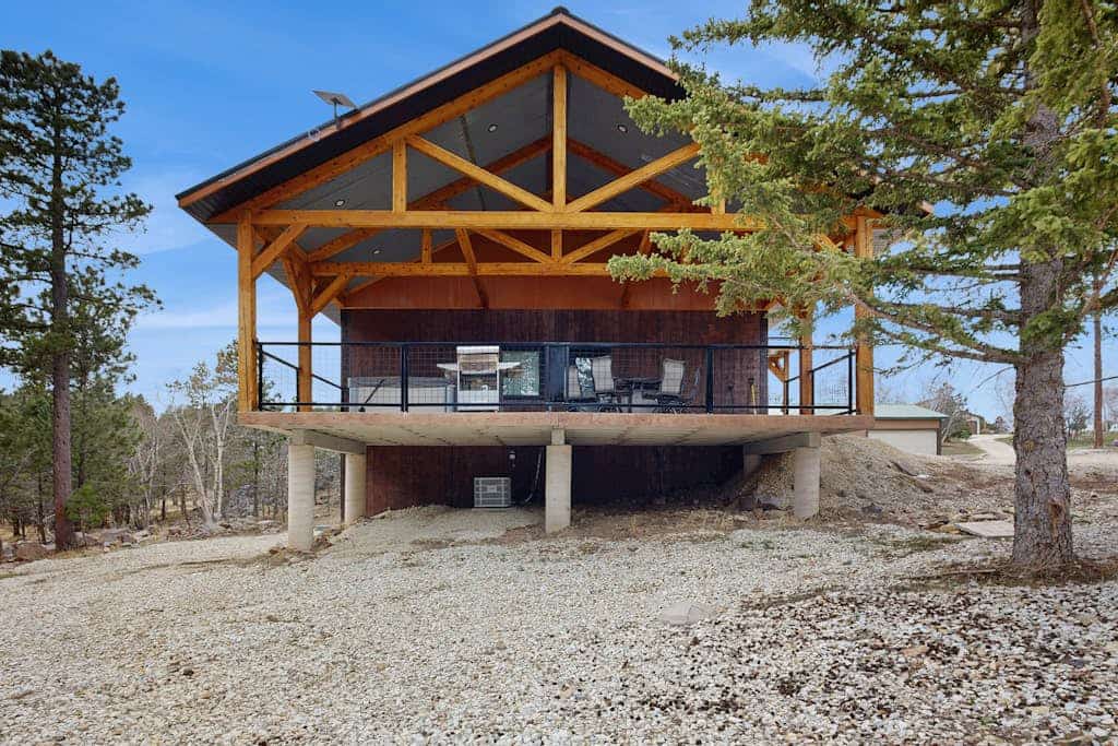 Escape to Bear Butte Hideaway, a stunning 6-bedroom mountain retreat in Deadwood, South Dakota. This newly built home features a private hot tub, gourmet kitchen, and six king-sized bedrooms, offering the perfect blend of luxury and rustic charm. Relax by the fireplace or enjoy breathtaking mountain views from your balcony. Ideally located minutes from historic Deadwood casinos and iconic landmarks like Mount Rushmore, this spacious getaway is the ultimate basecamp for your next family reunion or Black Hills adventure.