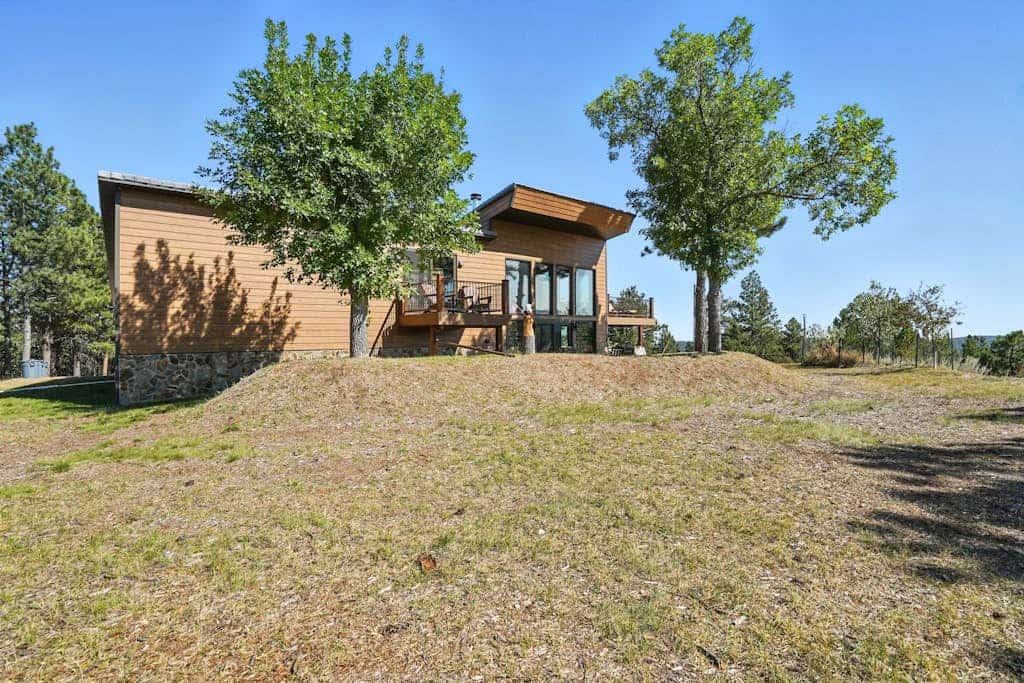 Experience pure mountain magic at this luxury 2-bedroom lodge perched on 17 private acres in the Black Hills. Enjoy stunning, unobstructed views of Mount Rushmore from your private deck, soak in the south-facing hot tub, or unwind in the dedicated theater room. This secluded retreat balances rustic charm with modern elegance, placing you minutes from Custer State Park and Crazy Horse. Whether you are stargazing by the fire table or exploring local trails, this is your perfect Black Hills sanctuary.