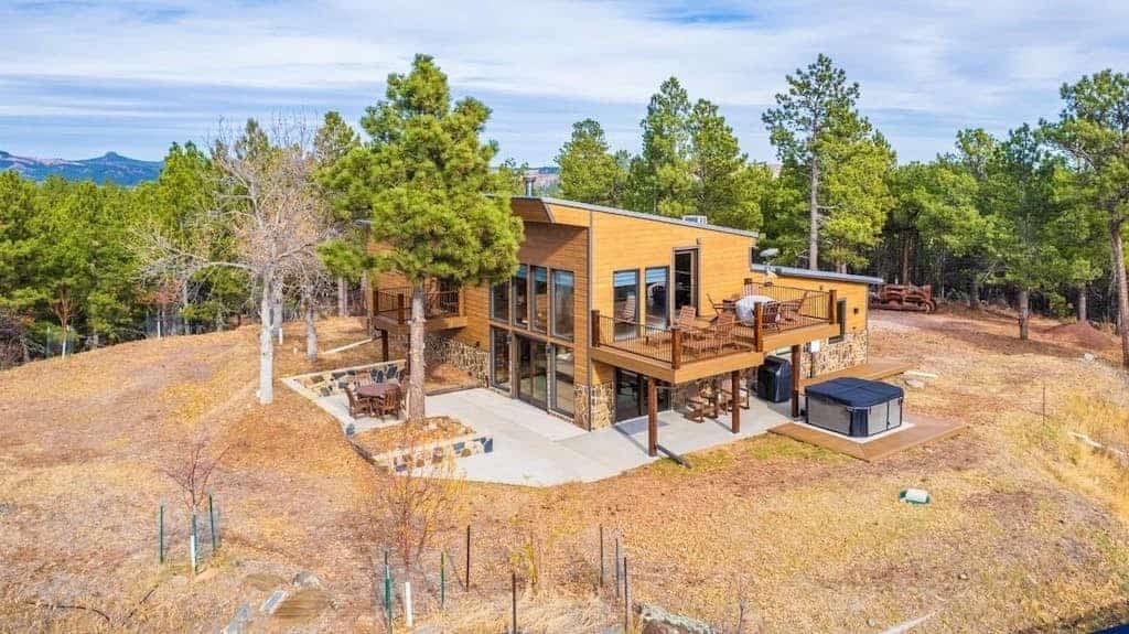 Experience pure mountain magic at this luxury 2-bedroom lodge perched on 17 private acres in the Black Hills. Enjoy stunning, unobstructed views of Mount Rushmore from your private deck, soak in the south-facing hot tub, or unwind in the dedicated theater room. This secluded retreat balances rustic charm with modern elegance, placing you minutes from Custer State Park and Crazy Horse. Whether you are stargazing by the fire table or exploring local trails, this is your perfect Black Hills sanctuary.