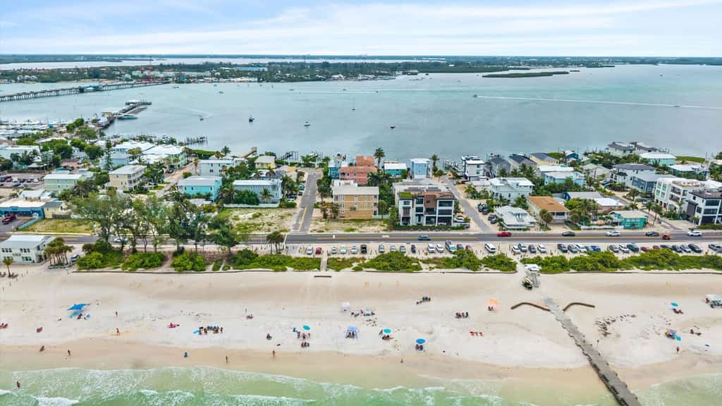 Welcome to The Pearl, a luxurious oceanfront Anna Maria Island vacation home where white-sand beaches and historic charm are just steps from your front door. 

This 6-bedroom home is divided into two apartments with 3-bedrooms and 2.5 baths each, giving your large group plenty of space and privacy. Each floor offers unique and cozy coastal decor, an open-floor plan living room, secondary bedrooms sharing a Jack-and-Jill bath, and a primary suite with a king-sized bed, private oceanview balcony, and spa bath with garden tub. The expansive backyard offers plenty of shaded space for dining and relaxing, along with an outdoor television, heated pool, and putting green. 

Prepare and enjoy family meals in the stocked, ocean-view kitchen and informal dining room, or take advantage of shaded outdoor dining on the patio. Not in the mood to cook? Local favorites are just three blocks away at Historic Bridge Street, the epicenter of South AMI dining and nightlife. 

When its time for the beach, you'll have everything you need, including towels, chairs, and umbrellas.

Key Features & Highlights:
Prime Location: This Anna Maria Island vacation home is located directly across the street from Cortez Beach, putting you just steps away from the ocean.  Historic Bridge Street's dining, shopping and nightlife are just three blocks away.
Light & Airy Living: Open-concept living space designed for gathering with family or friends offers ocean views from the kitchen, dining nook, living room, and primary bedroom.
Beach Ready: Beach gear included so you can sink your toes into the sand from day one!

Book now and see why this expansive oceanview vacation home is truly The Pearl of Anna Maria Island. 