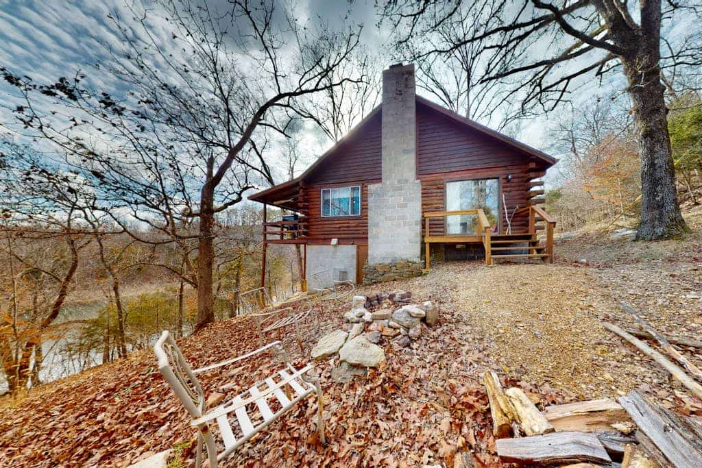 Lakefront dog-friendly log cabin with private boat access, firepit, & grill