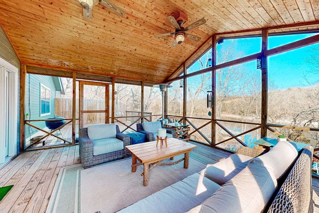 Lakefront retreat with screened sunroom, wood stove, multiple decks, & AC