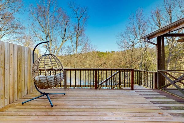 Lakefront retreat with screened sunroom, wood stove, multiple decks, & AC