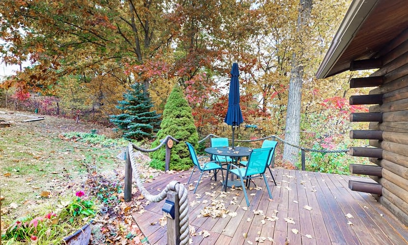 1-acre lakefront log cabin with dock, 50 ft water frontage, hot tub, & deck