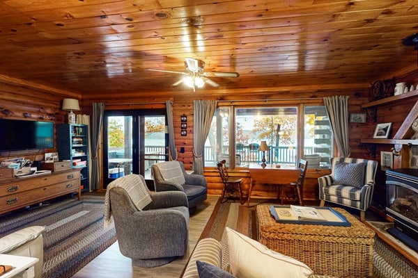 1-acre lakefront log cabin with dock, 50 ft water frontage, hot tub, & deck