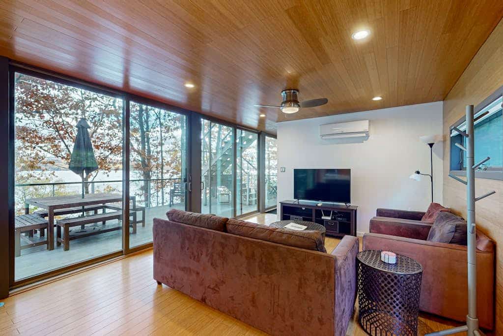 Lakefront contemporary gem with decks, lake views & pebble beach