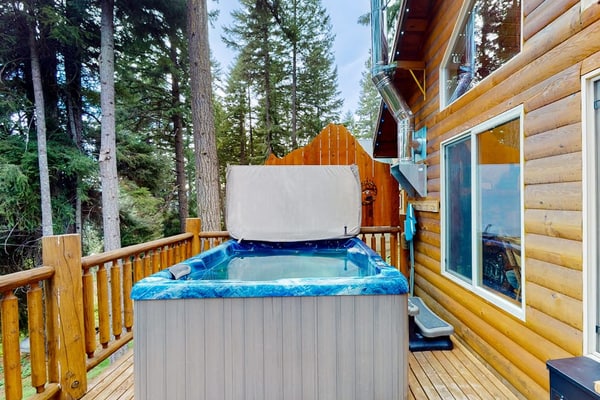Three-story, dog-friendly home with a private hot tub, firepit, & wood stove