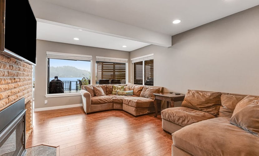 Sprawling lakefront property with kayaks, large deck, game table, & fireplace