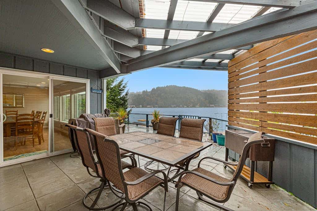 Sprawling lakefront property with kayaks, large deck, game table, & fireplace