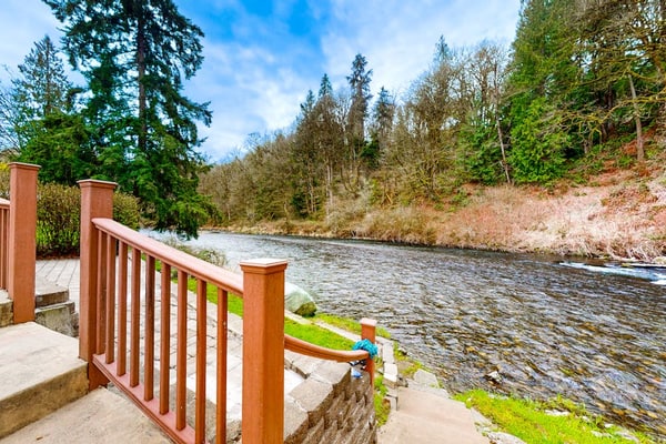 Dog-friendly riverfront home with patio, golf nearby, enclosed yard, & W/D