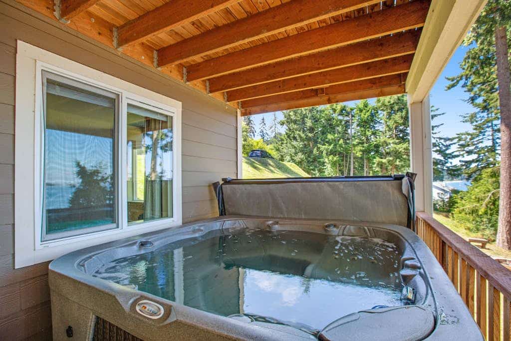 Beachfront 3-story home w/deck, bay views, hot tub, game room, WiFi, EV charger