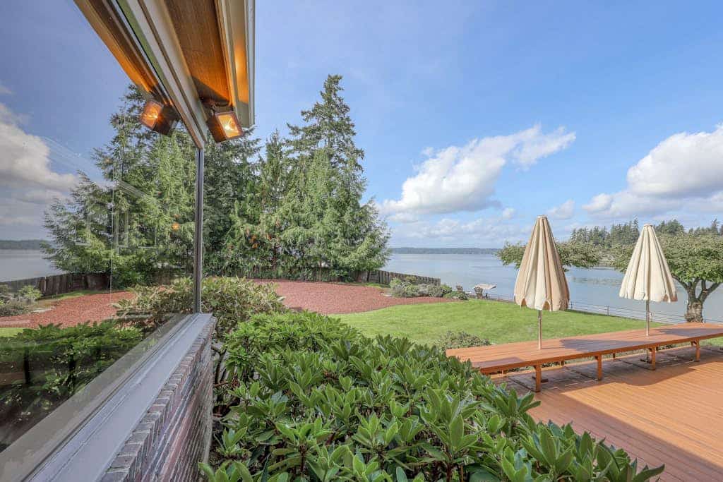 Waterfront home & on-site guest house w/ full kitchens, a large deck, & firepits