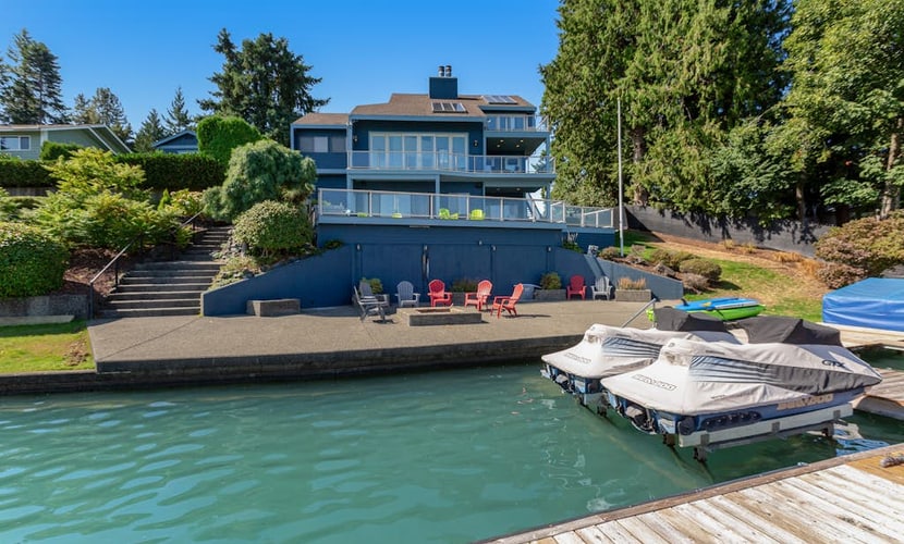Peaceful lakefront home with firepit, hot tub, pool table, dock, balcony, & deck