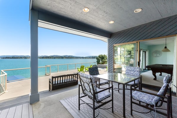 Peaceful lakefront home with firepit, hot tub, pool table, dock, balcony, & deck