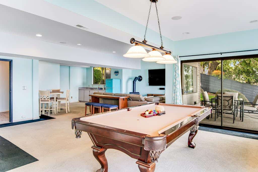 Peaceful lakefront home with firepit, hot tub, pool table, dock, balcony, & deck