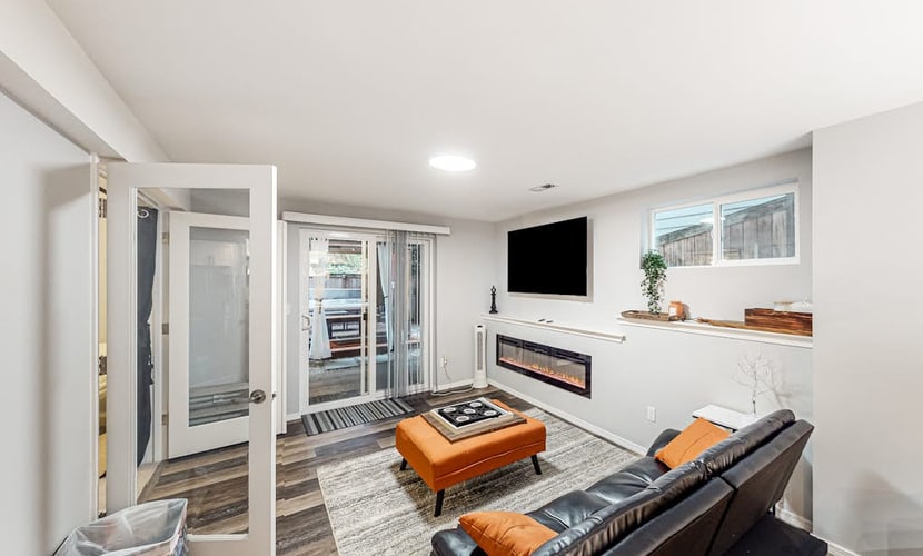 Modern lower-level getaway with a fireplace, inviting patio & washer/dryer
