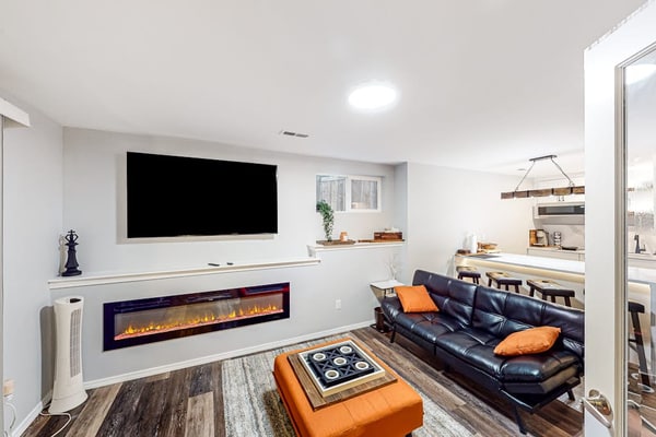 Modern lower-level getaway with a fireplace, inviting patio & washer/dryer