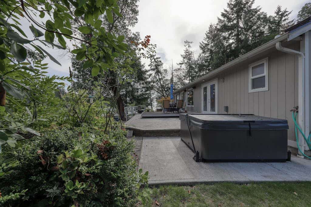 Spacious waterfront home with hot tub, large decks, kayaks, and beach access