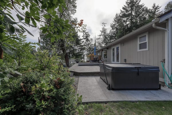 Spacious waterfront home with hot tub, large decks, kayaks, and beach access