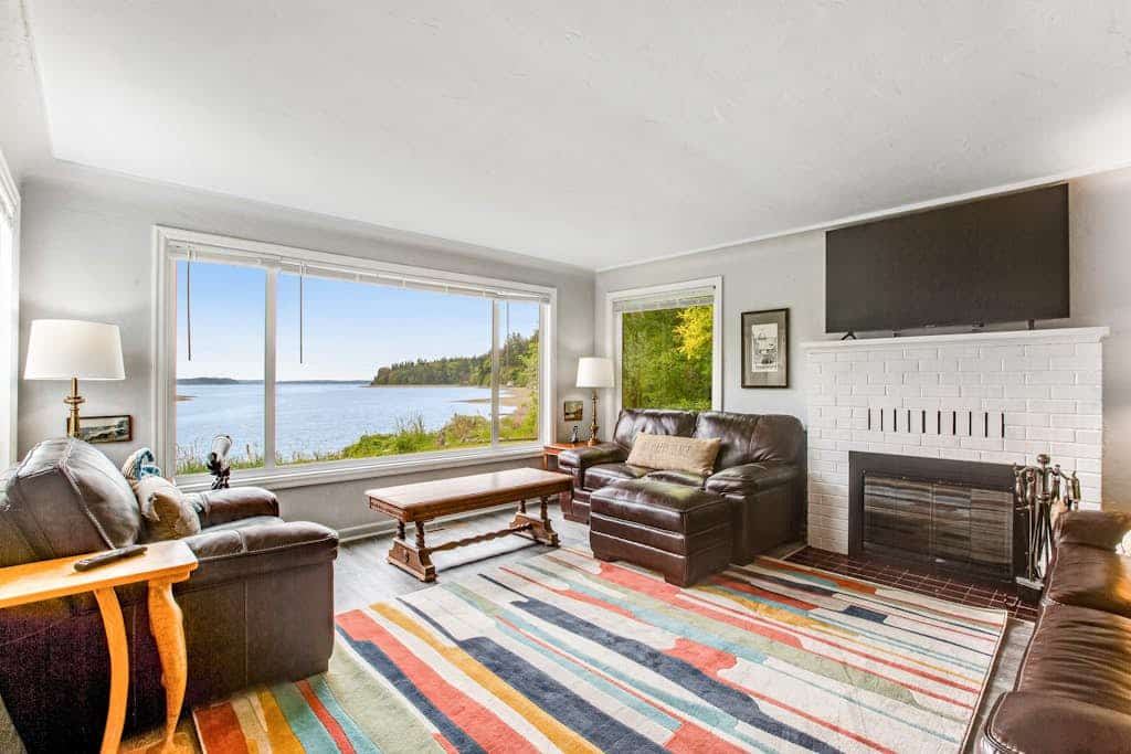 Waterfront retreat with private beach, cookhouse, hot tub, EV charger, & firepit