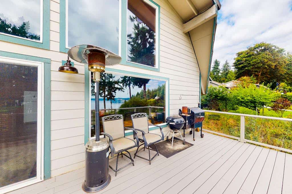 Sound view home full of vintage charm with game room, wood stove, & gas grill