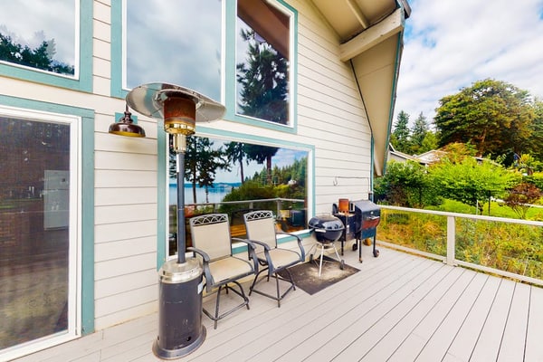 Sound view home full of vintage charm with game room, wood stove, & gas grill