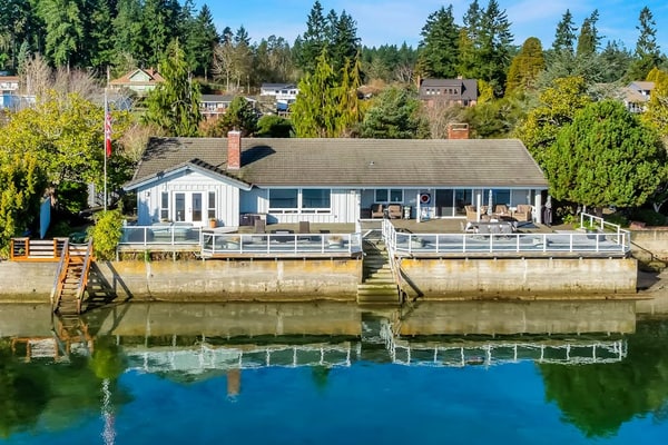 Waterfront home with private hot tub, game room with game tables, and water toys