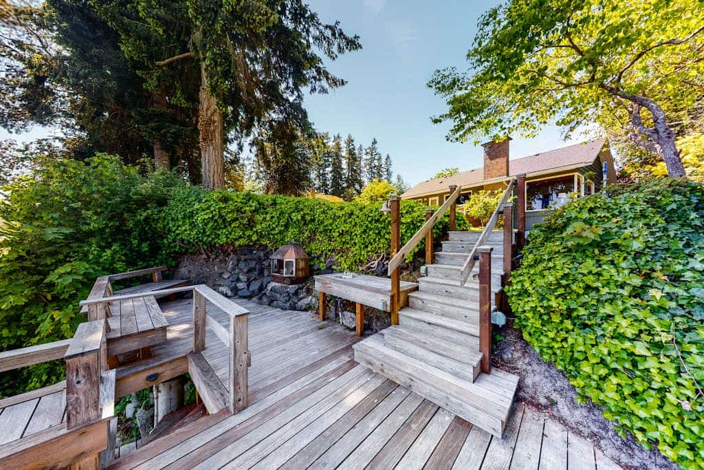 Inviting bayside dwelling with beach access, deck, waterfront views, & fireplace