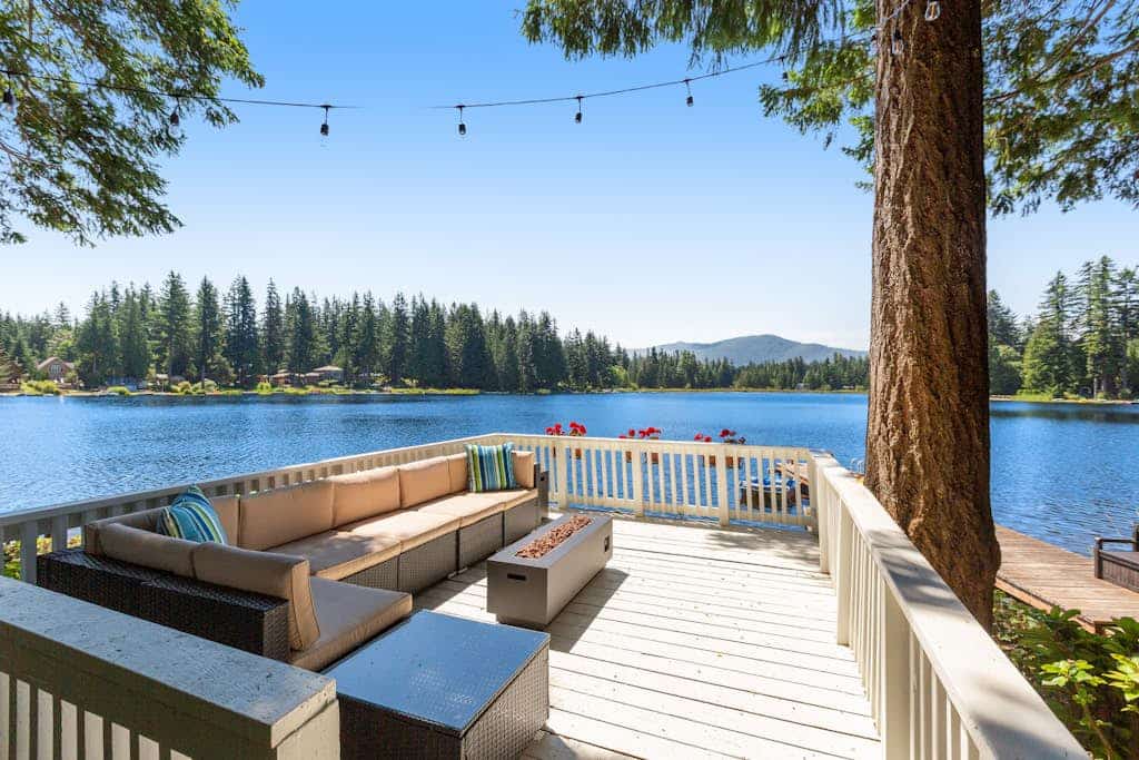 Luxe lakeside cottage with furnished porch, 2 docks, fire pit, deck, beachfront