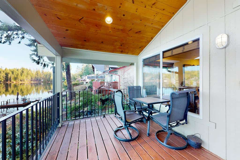 Lakefront studio-like home with beach access, lake views, wood stove, & firepit