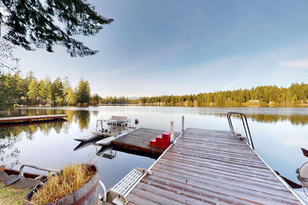 Lakefront studio-like home with beach access, lake views, wood stove, & firepit