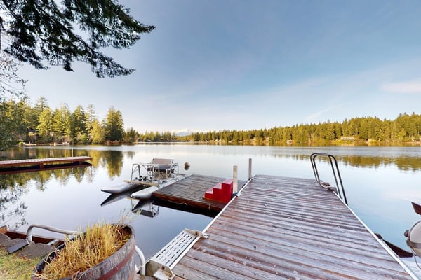 Lakefront studio-like home with beach access, lake views, wood stove, & firepit