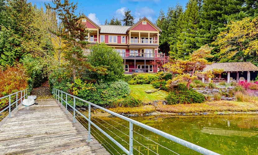 Luxury waterfront home with hot tub, dock, game room, and stunning views