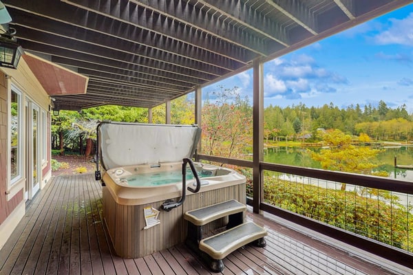 Luxury waterfront home with hot tub, dock, game room, and stunning views