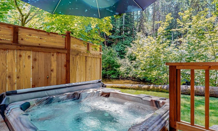 Rare, dog-friendly riverfront retreat with hot tub access plus kayaks & AC