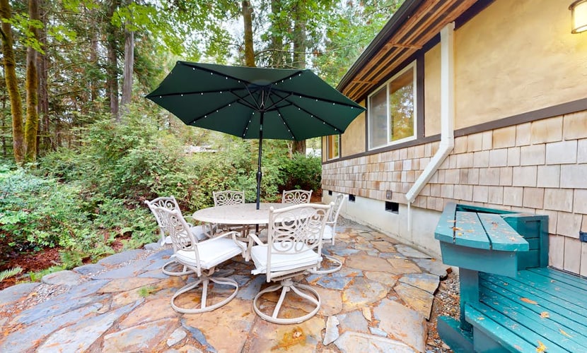 Tree-lined retreat with wood fireplace, board game collection, & pool access