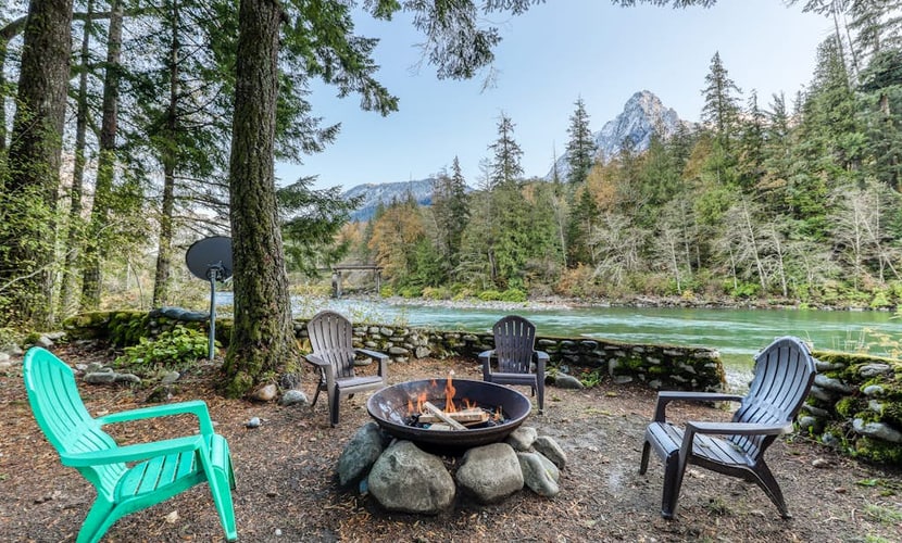 Dog-friendly cottage on the river with private hot tub, mountain views & firepit