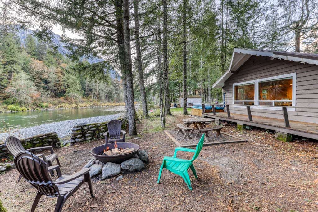 Dog-friendly cottage on the river with private hot tub, mountain views & firepit