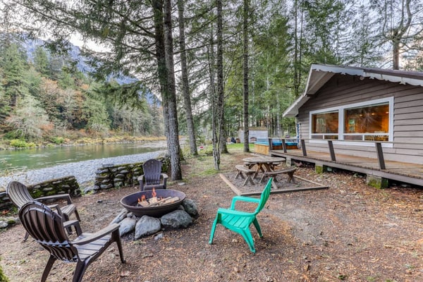 Dog-friendly cottage on the river with private hot tub, mountain views & firepit