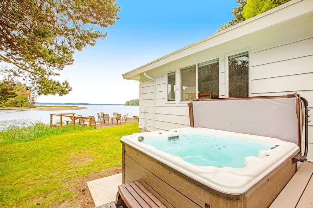 Waterfront retreat with private beach, firepit, kayaks/SUP, EV charger & grill