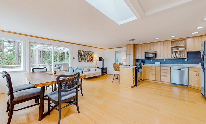 Modern water view retreat with foosball table, expansive deck, and gas fireplace
