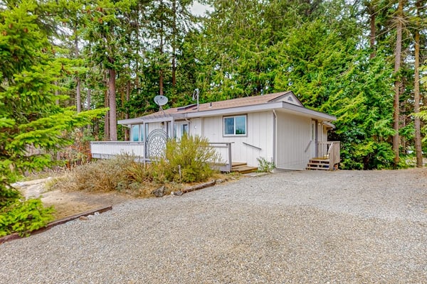 Modern water view retreat with foosball table, expansive deck, and gas fireplace