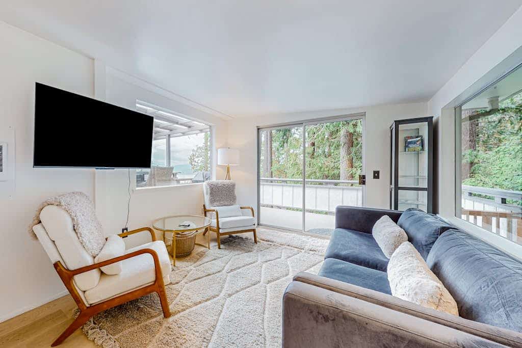 Modern water view retreat with foosball table, expansive deck, and gas fireplace