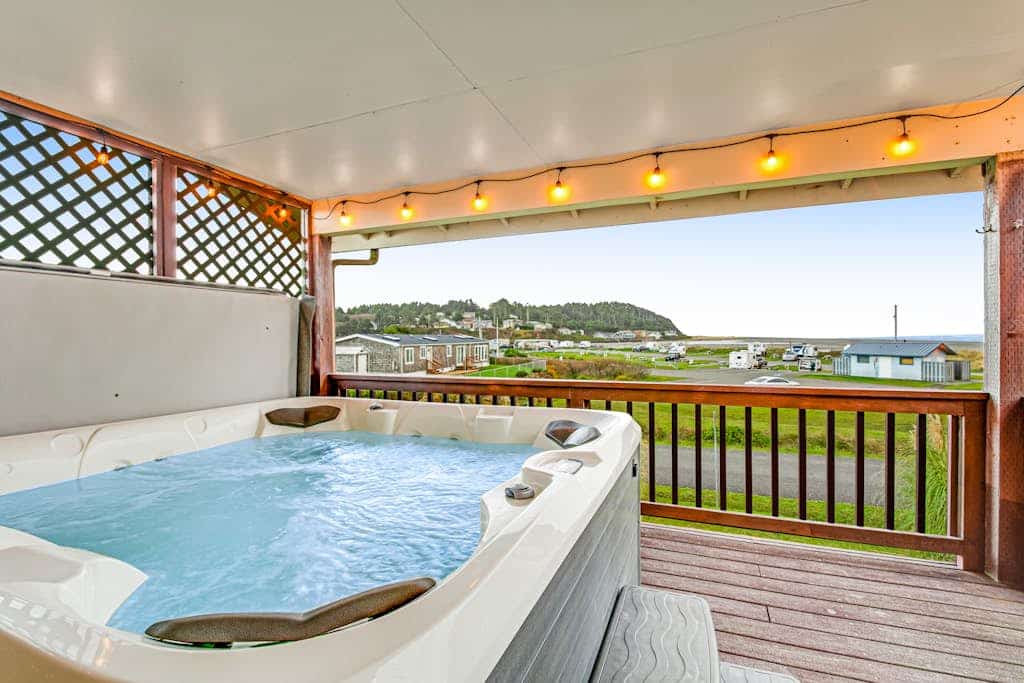 Spacious coastal home with private hot tub, ocean view, wood stove & EV charging