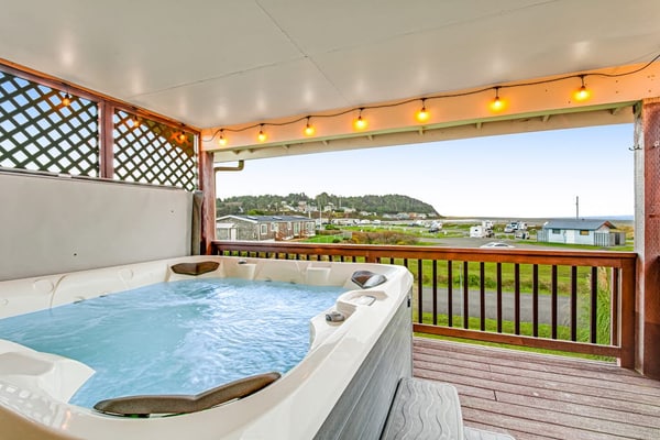 Spacious coastal home with private hot tub, ocean view, wood stove & EV charging