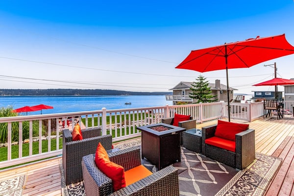Dog-friendly home with a great deck, ocean view & firepit on beachfront lawn